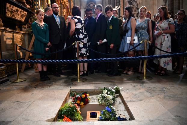 Members of the congregation file past the ashes of British scientist Stephen Hawking at the site of their interment in the nave of the Abbey church, during a memorial service at Westminster Abbey, in London