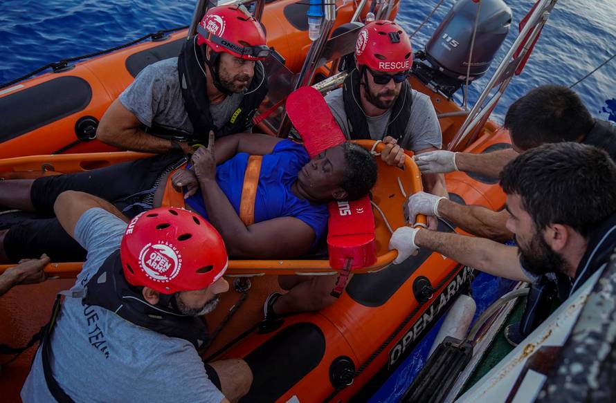 NBA Memphis player Marc Gasol and members of NGO Proactiva Open Arms rescue boat carry African migrant in central Mediterranean Sea