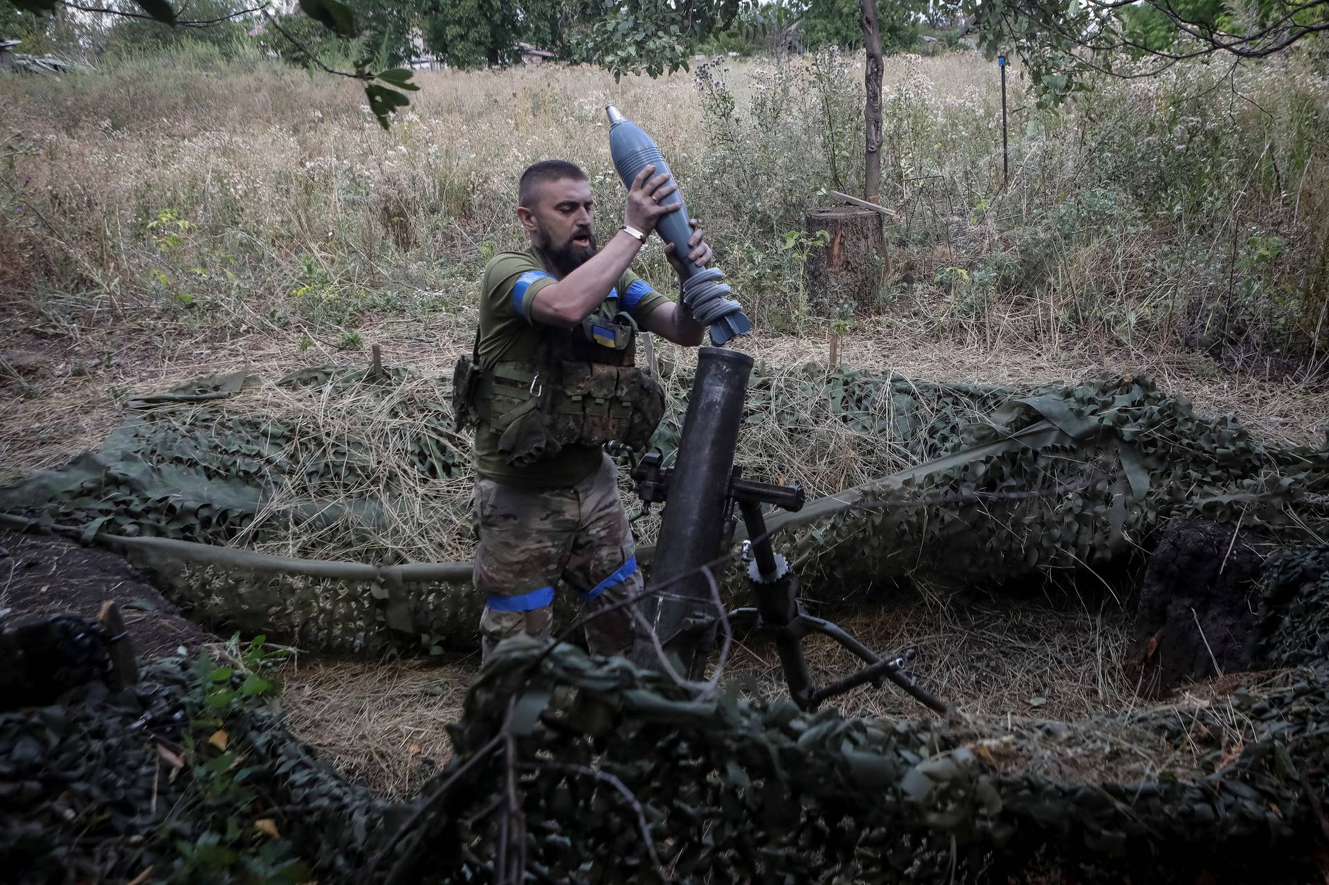 Ukrainian servicemen fires a 120-mm mortar towards Russian troops at a frontline near the town of Chasiv Yar