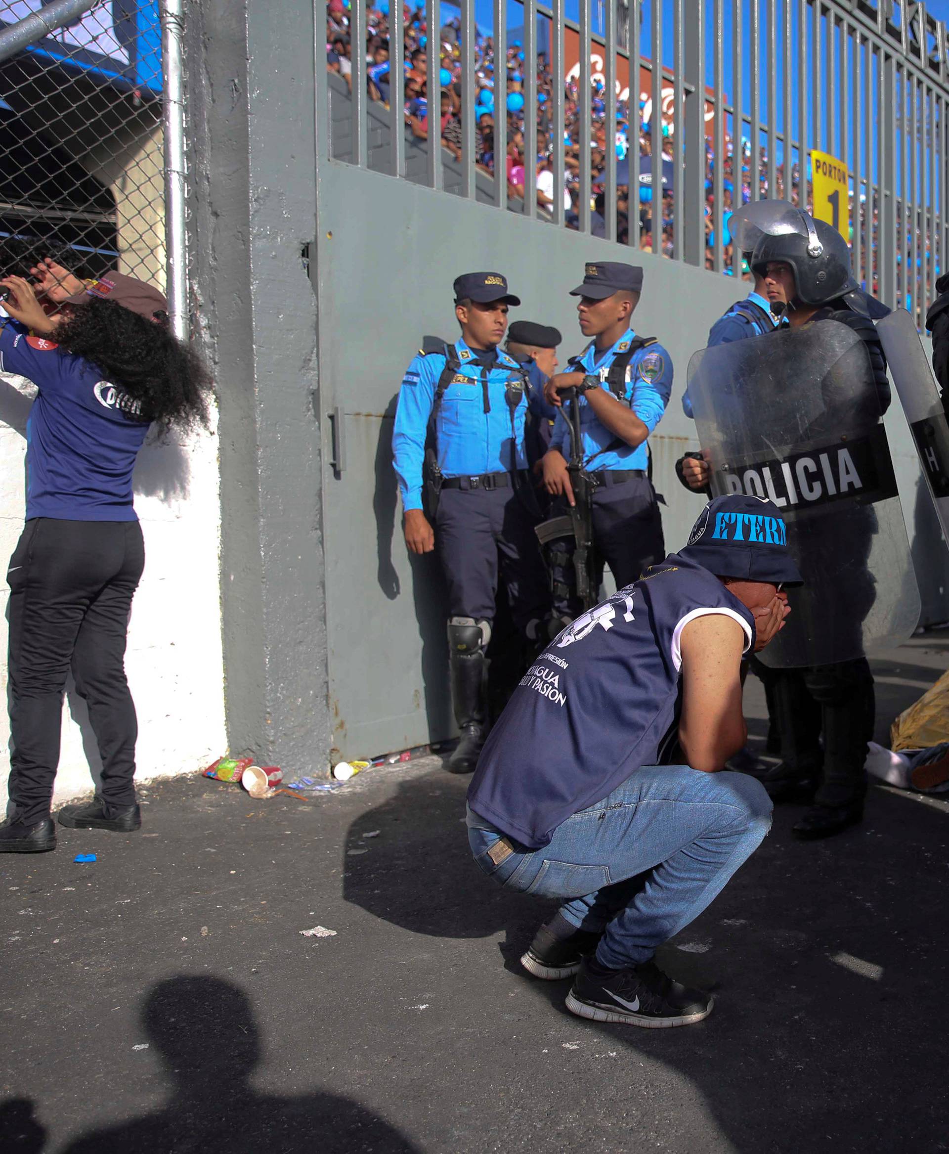 A man reacts after an stampede at the National Stadium in Tegucigalpa