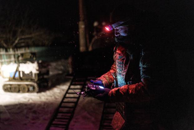 Ukrainian servicemen operate an unmanned ground vehicle fit for delivery missions on the frontline in Donetsk region
