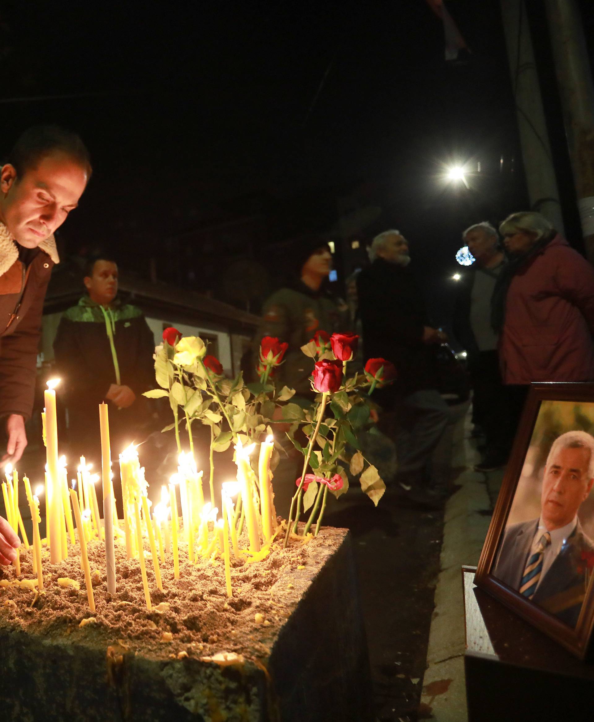 People gather to commemorate Kosovo Serb leader Oliver Ivanovic in front of his house in Kosovska Mitrovica