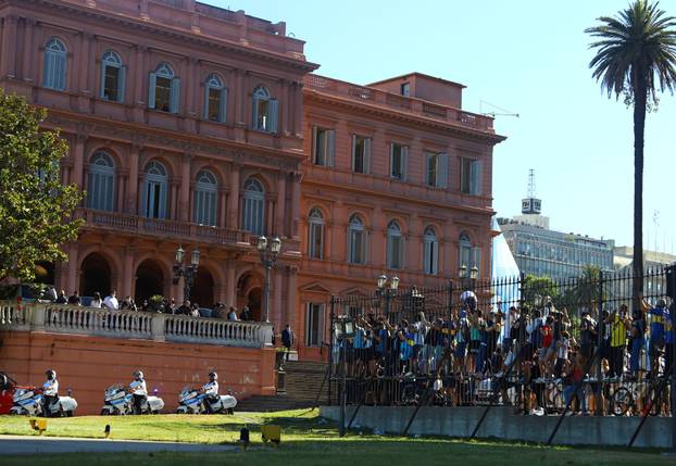 People react as the funeral procession with the casket of soccer legend Diego Maradona leaves the presidential palace Casa Rosada in Buenos Aires
