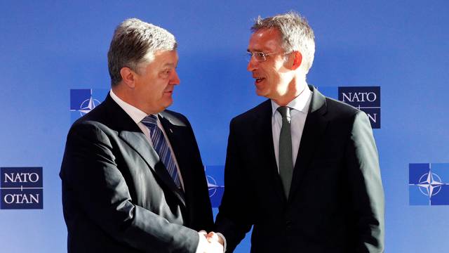 Ukrainian President Poroshenko poses with NATO's Secretary General Stoltenberg in Brussels