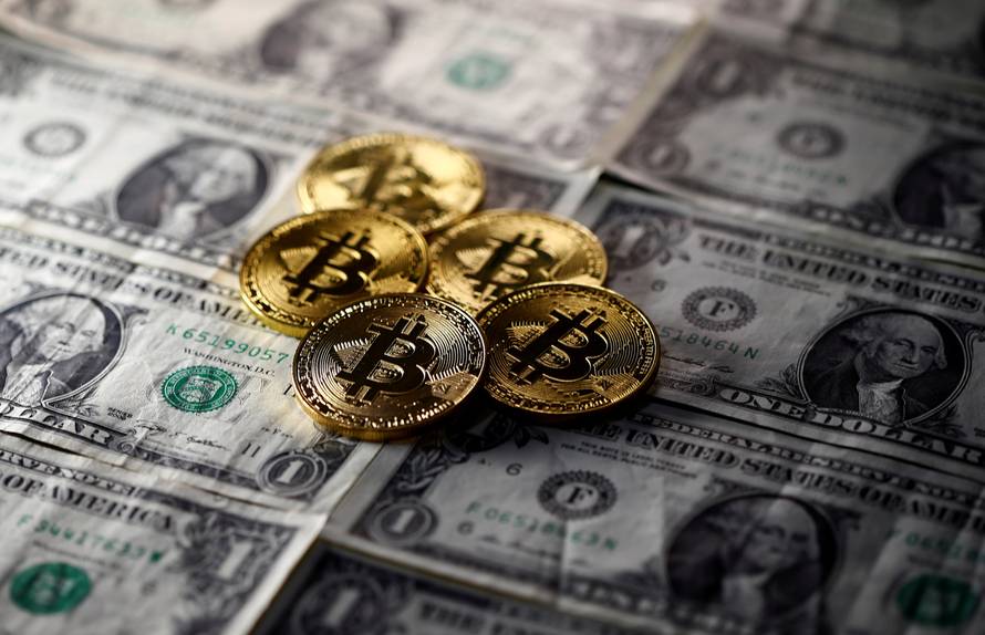 FILE PHOTO: Bitcoin (virtual currency) coins placed on Dollar banknotes are seen in this illustration picture