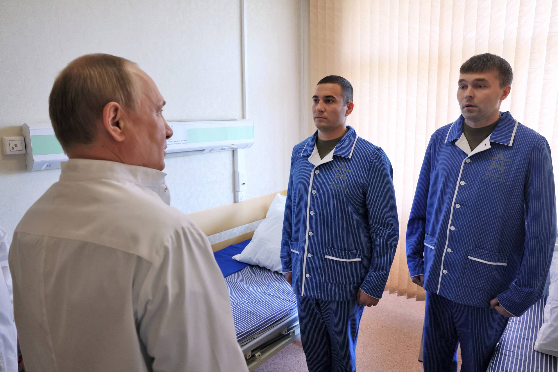 Russian President Vladimir Putin visits soldiers wounded during the conflict in Ukraine at a hospital in Moscow