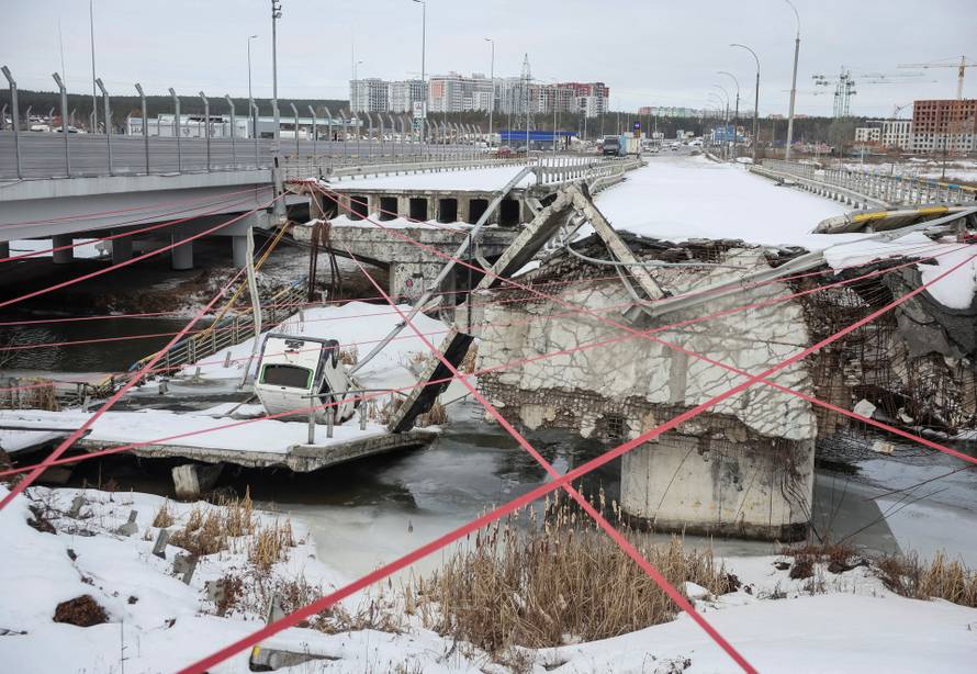 People attend a memorial event to mark the fourth anniversary of the full-scale Russian invasion in Irpin