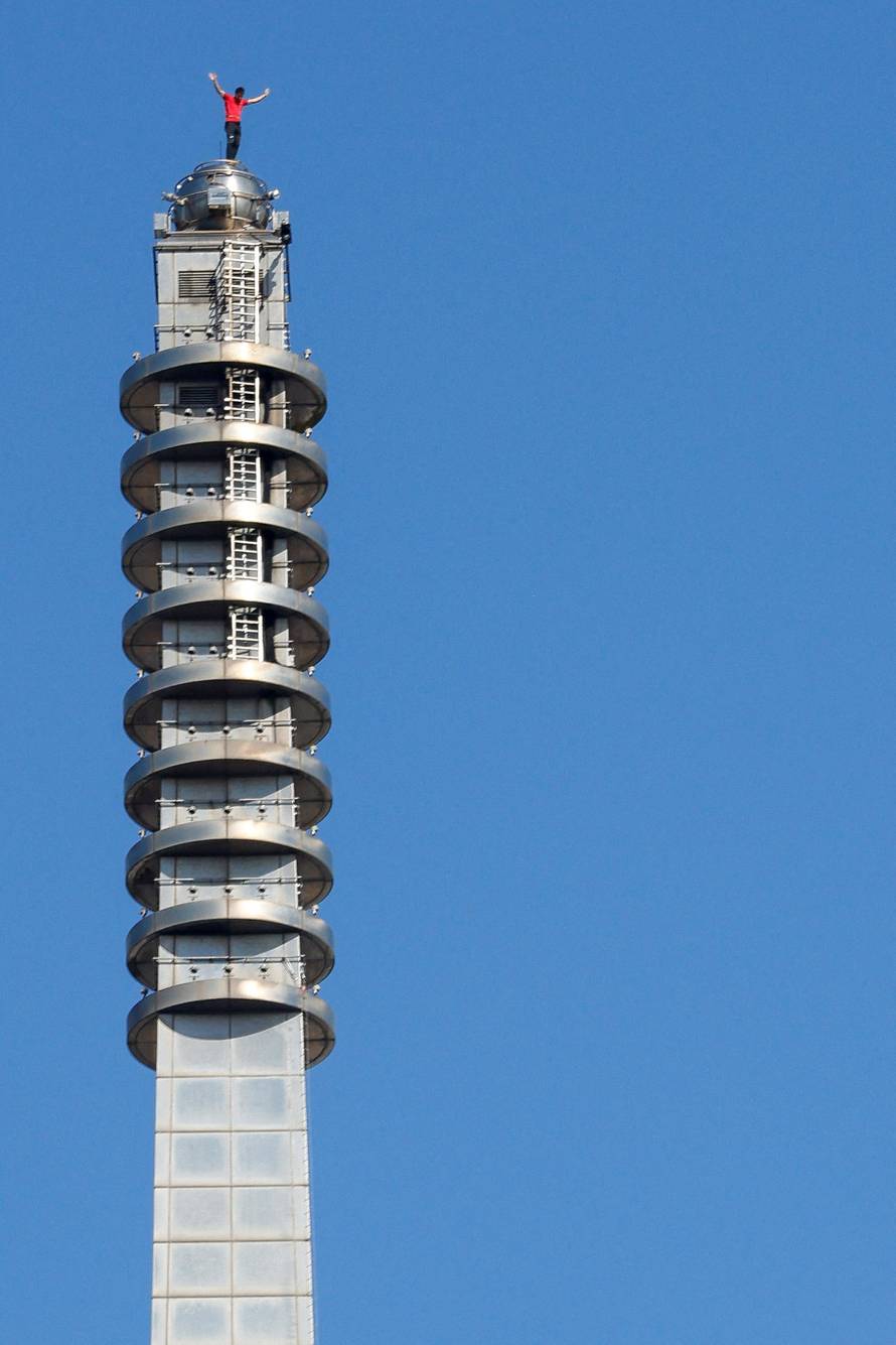 Climber Alex Honnold atop Taipei 101 after free soloing the skyscraper in Taipei