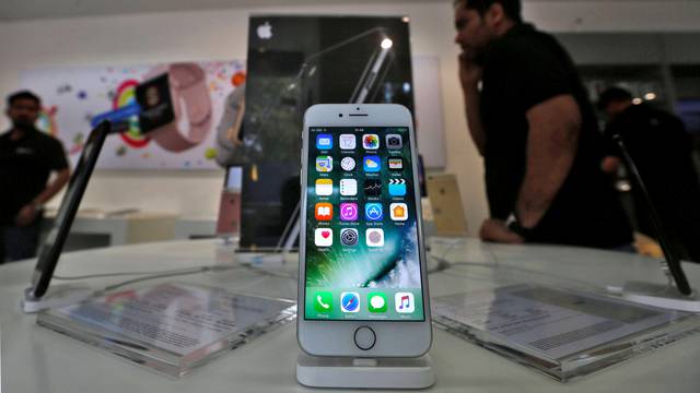 FILE PHOTO: An iPhone is seen on display at a kiosk at an Apple reseller store in Mumbai