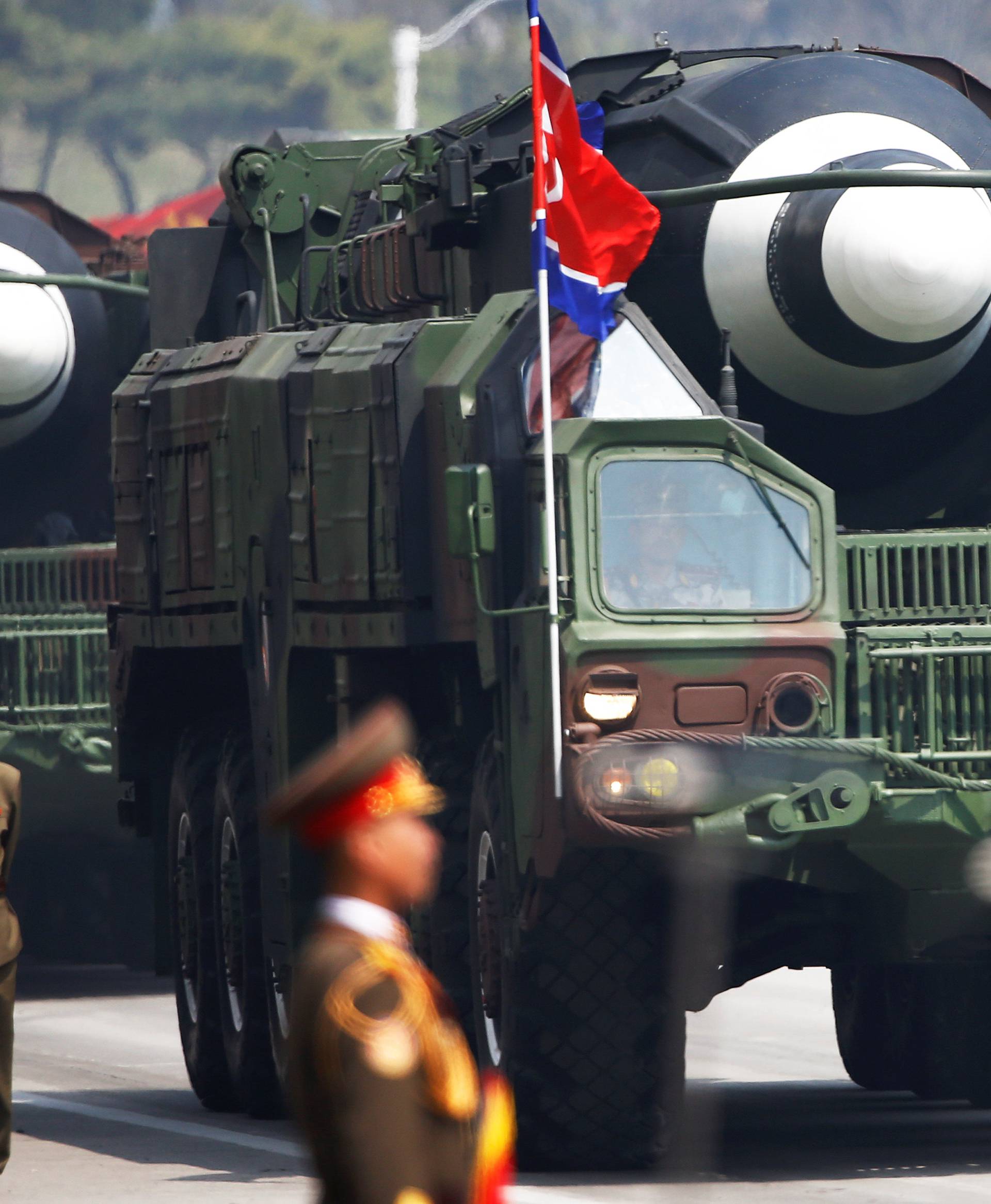 Missiles are driven past the stand with North Korean leader Kim Jong Un and other high ranking officials during a military parade marking the 105th birth anniversary of the country's founding father, Kim Il Sung in Pyongyang