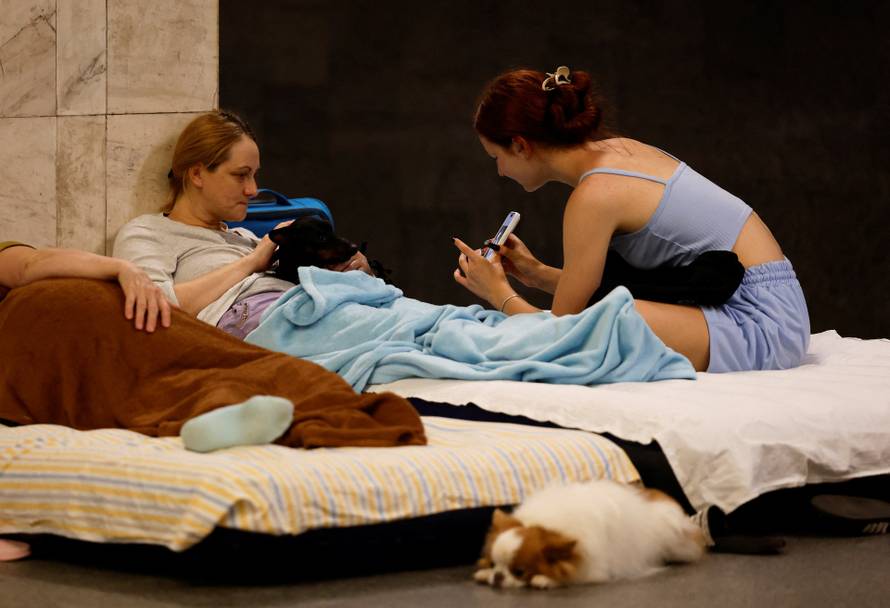 People take shelter inside a metro station during an air raid alert in Kyiv