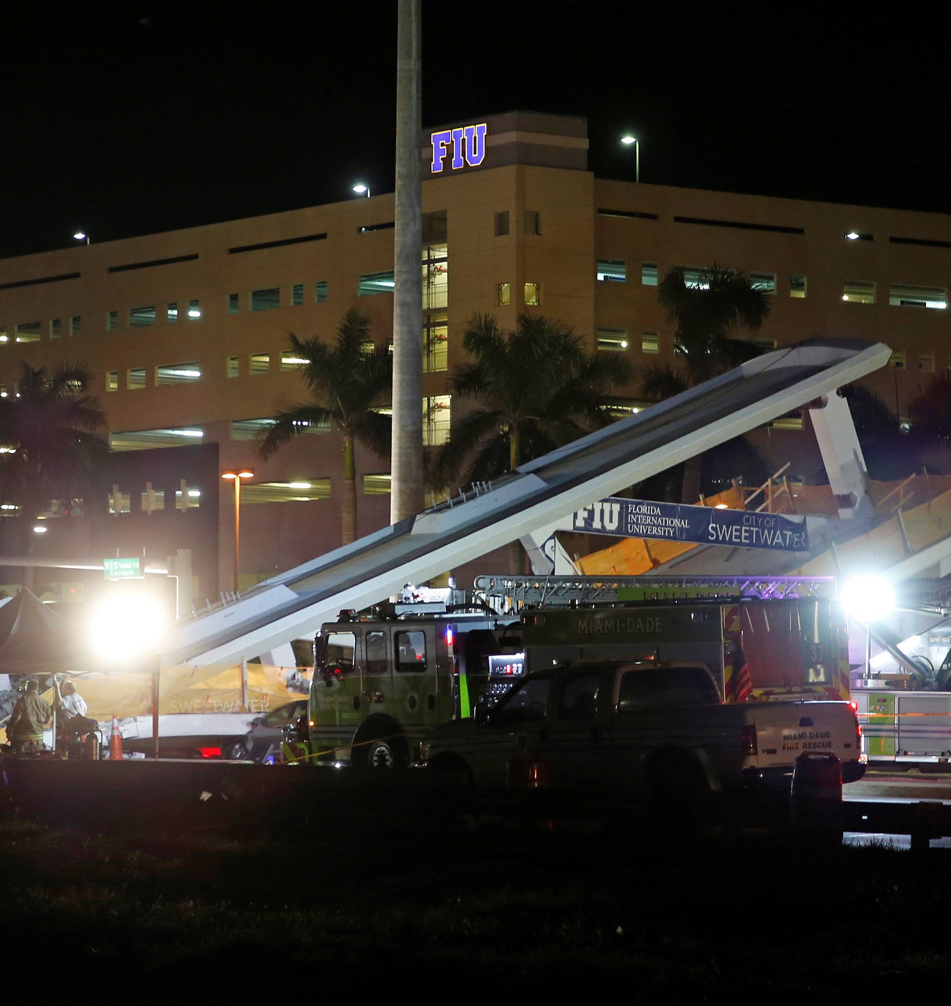 First responders are shown as rescue efforts continue after a pedestrian bridge collapsed at Florida International University in Miami