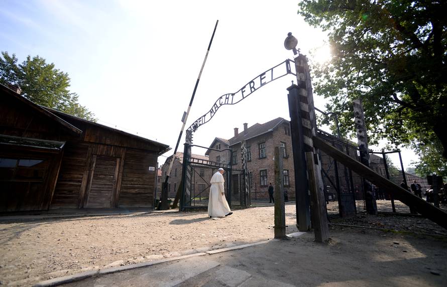 Pope Francis walks through Auschwitz's notorious gate during his visit to the former Nazi death camp