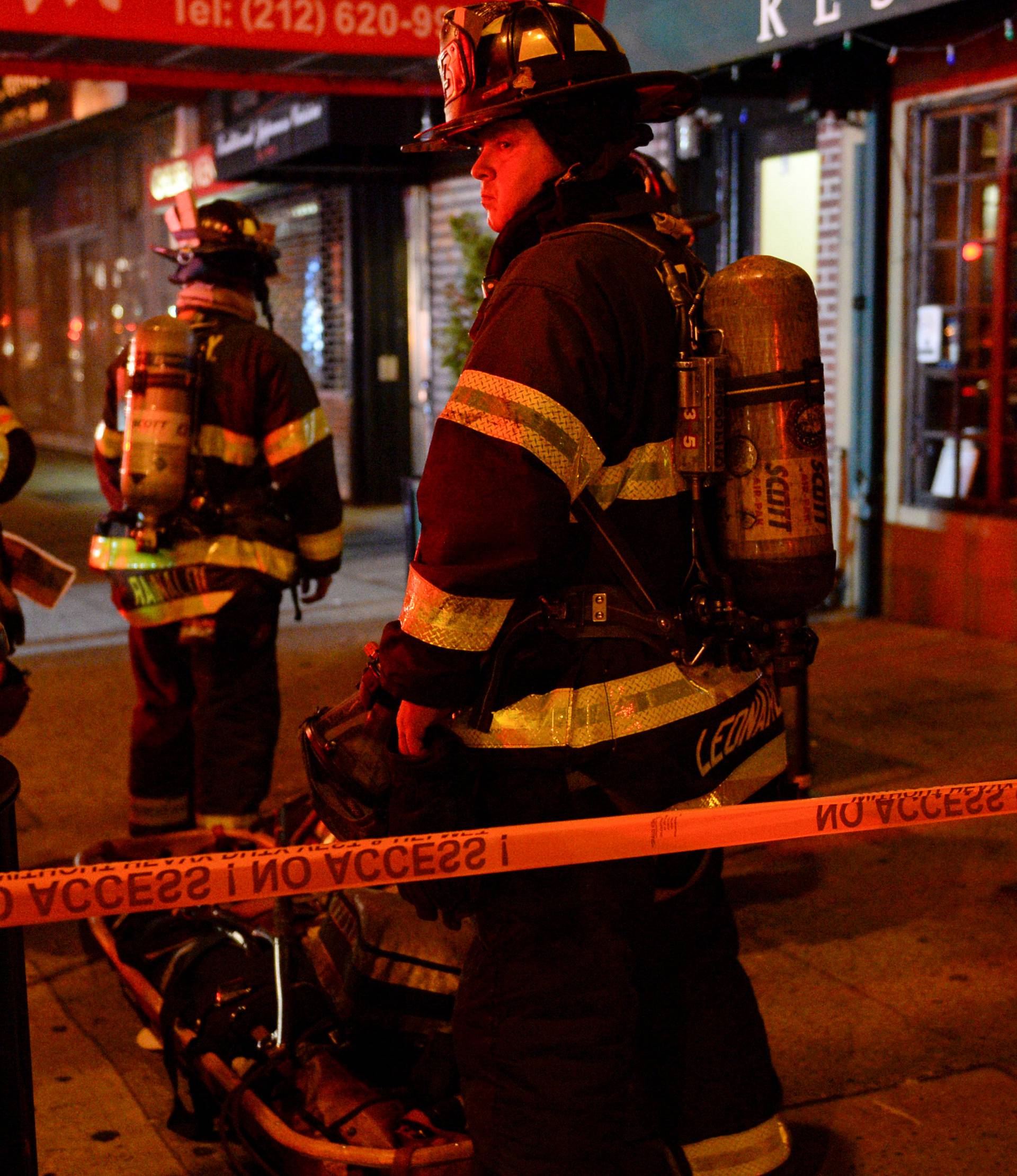 New York City firefighters stand near site of explosion in New York