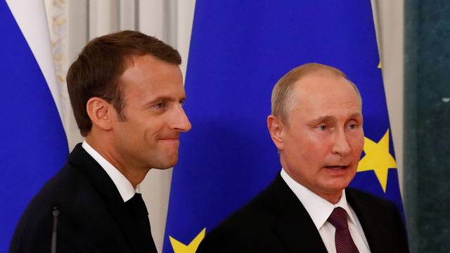 Russian President Putin and his French counterpart Macron leave after a news conference in St. Petersburg