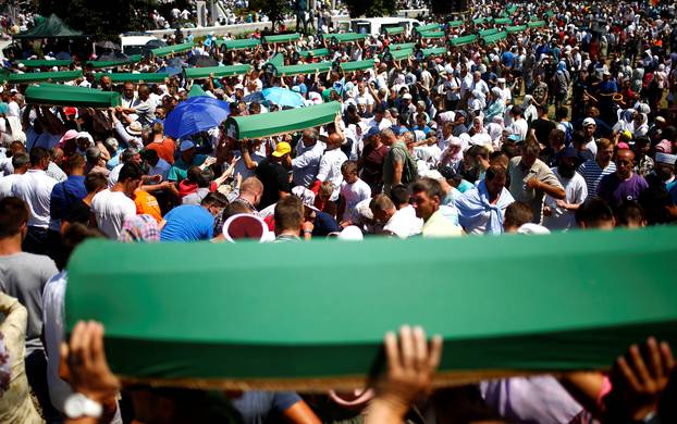 Muslim men carry coffins of their relatives, who are newly identified victims of the 1995 Srebrenica massacre, during mass funeral in Potocari near Srebrenica