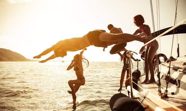 Friends,Relaxing,On,Their,Boat.,Making,A,Cruise,On,Sailing