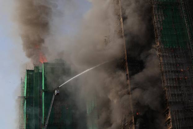 Flames engulf bamboo scaffolding across multiple buildings at Wang Fuk Court housing estate, in Tai Po