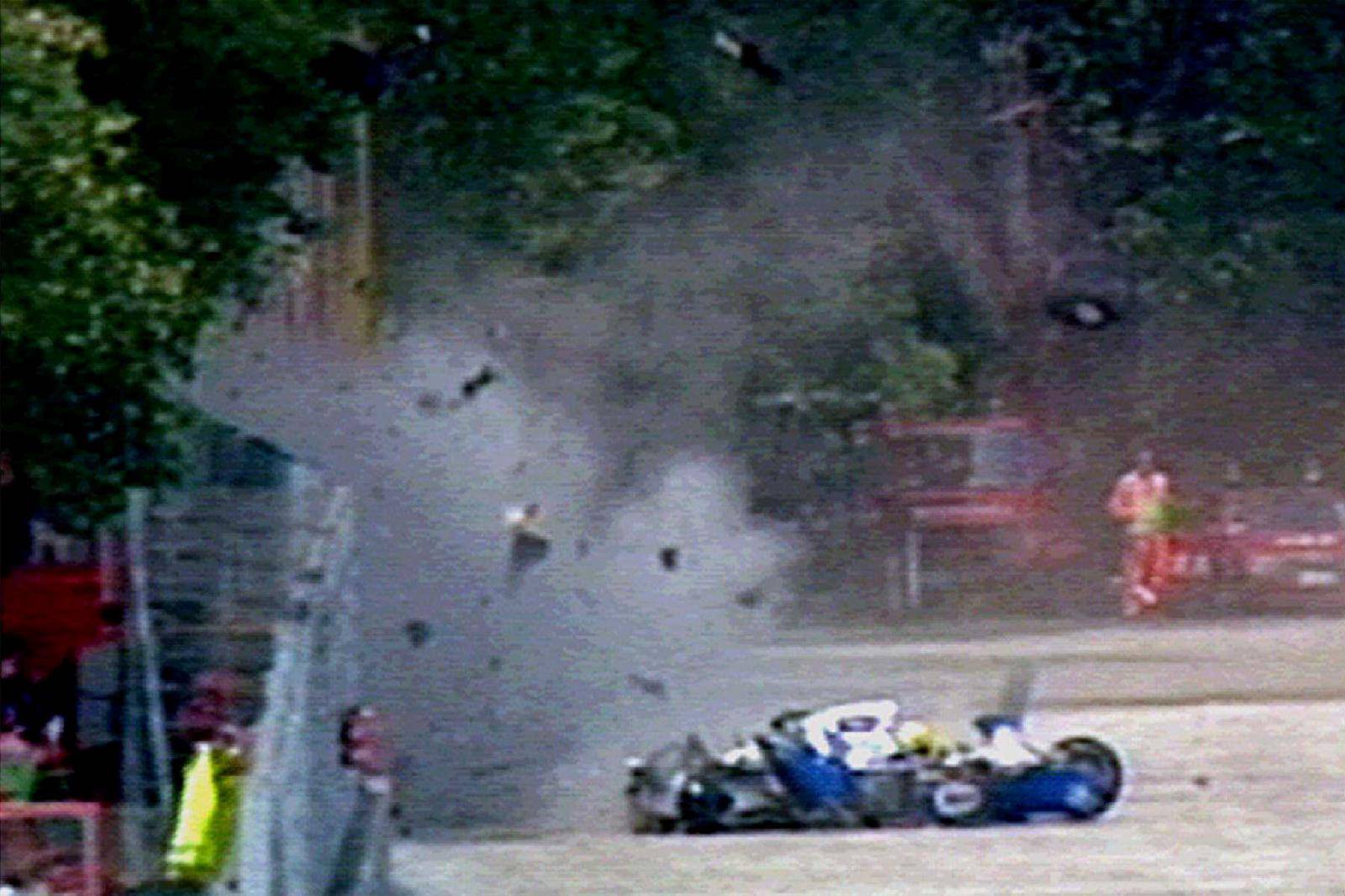 FILE PHOTO: Wreckage from three-time world champion Brazilian F-1 driver Senna's Williams-Renault car flies through the air in Imola