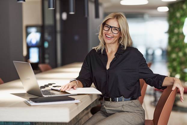 A,Professional,Woman,Diligently,Working,At,A,Modern,Workspace,With