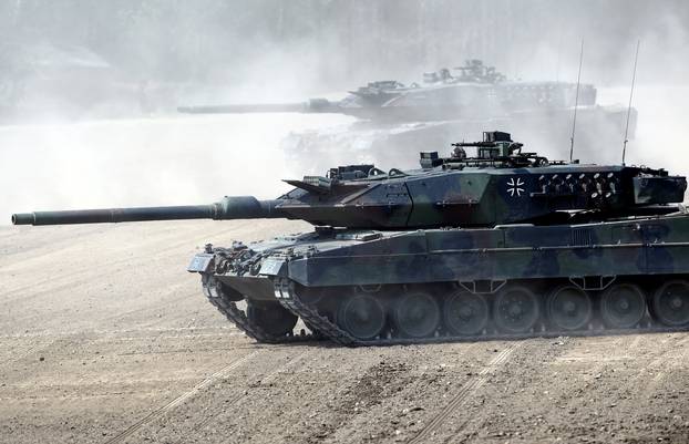 FILE PHOTO: Leopard 2 tanks take position during a visit of German Chancellor Angela Merkel at NATO new spearhead force "VJTF 2019" in Munster