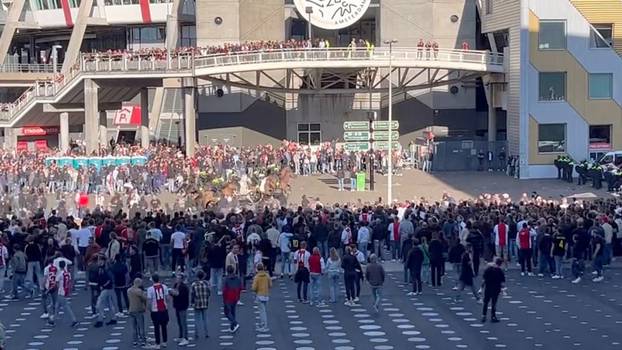 Police officers use teargas to disperse football fans rioting Johan Cruijff Arena