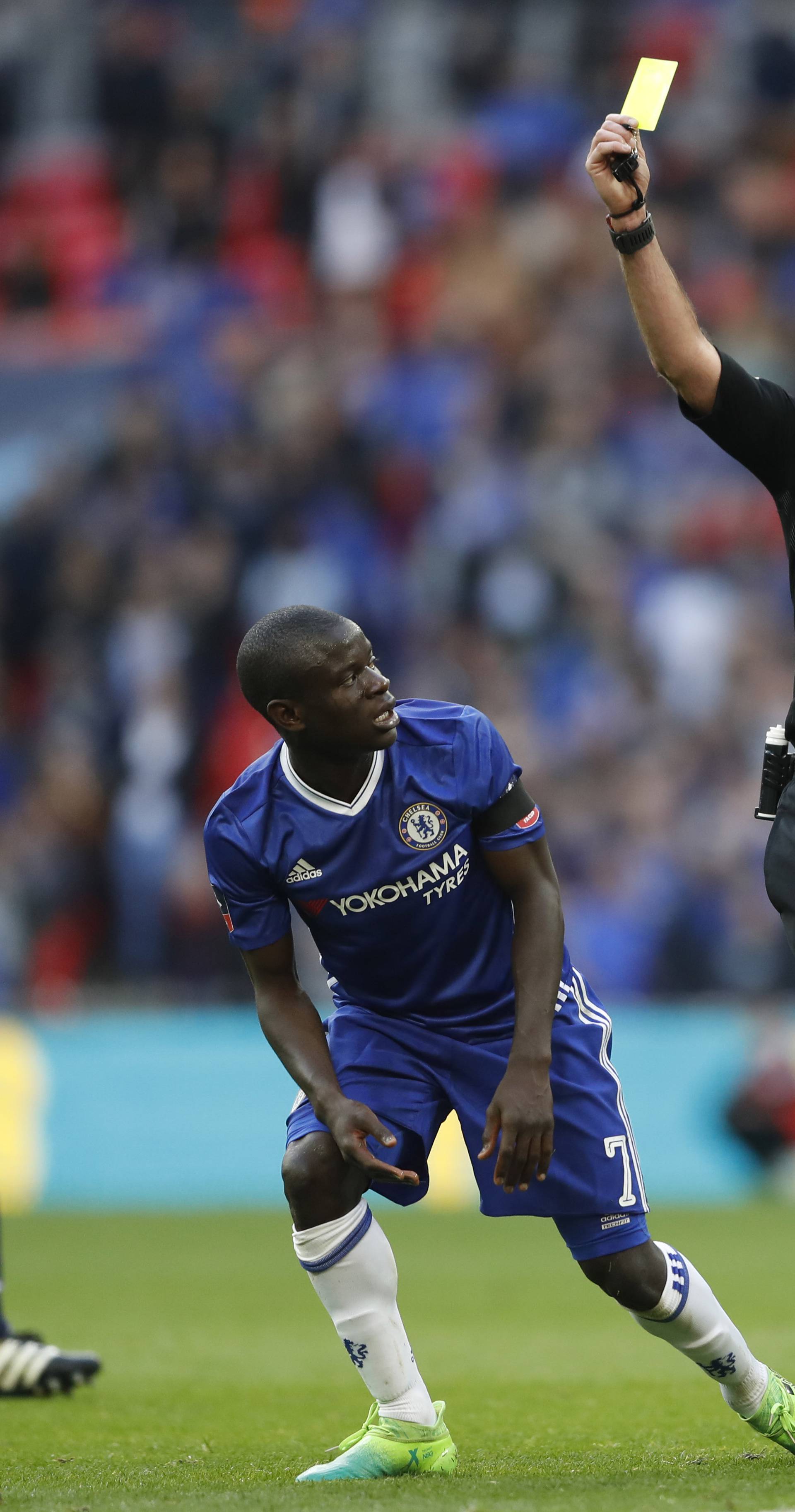 Chelsea's N'Golo Kante is shown a yellow card by referee Martin Atkinson for a foul on Tottenham's Dele Alli