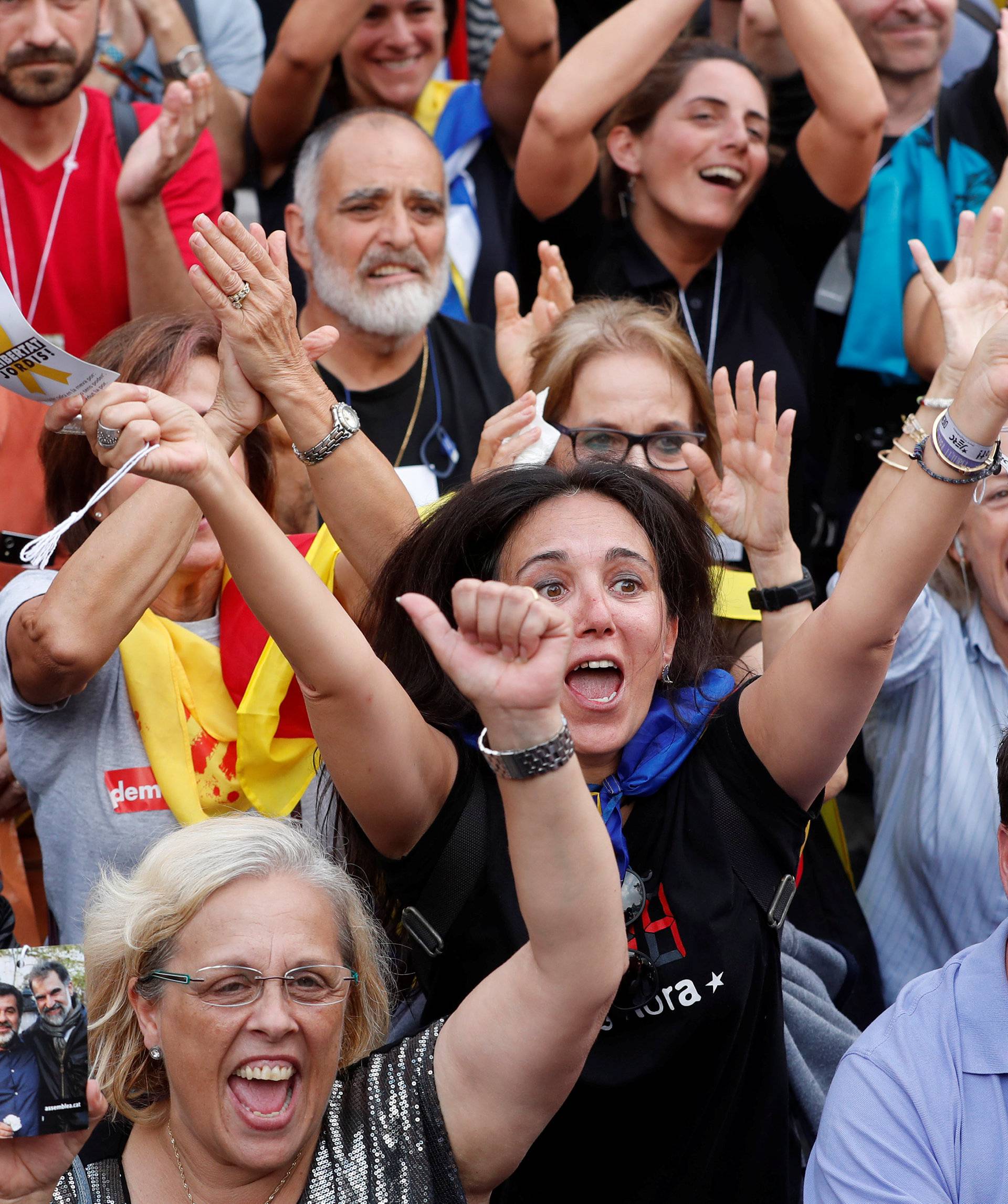 People react while the Catalan regional parliament votes for independence of Catalonia from Spain in Barcelona