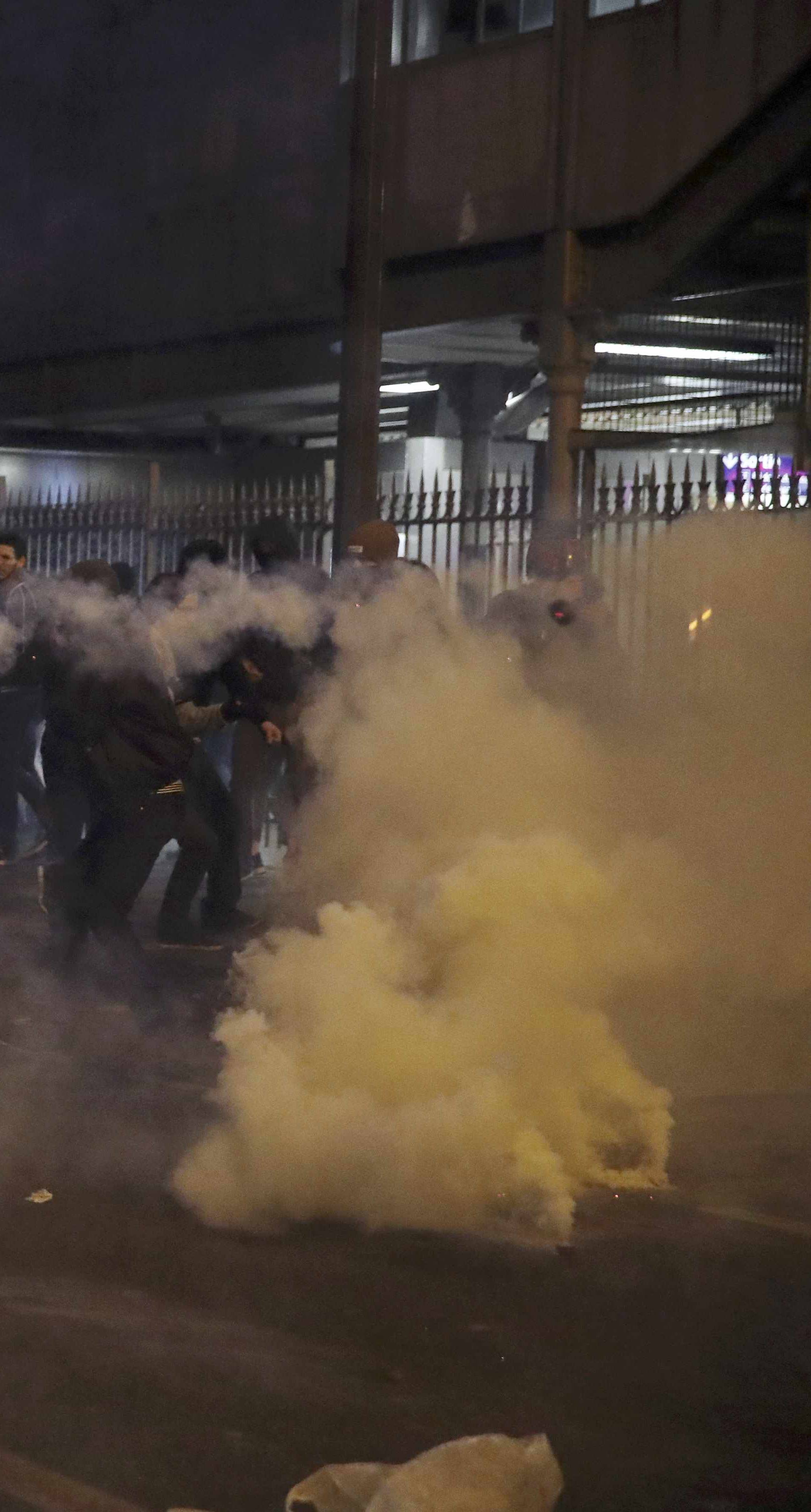  Clouds of tear gas surround people during a protest against police brutality after a young black man, 22-year-old youth worker named Theo, was severly injured, as people attend a demonstration in Paris