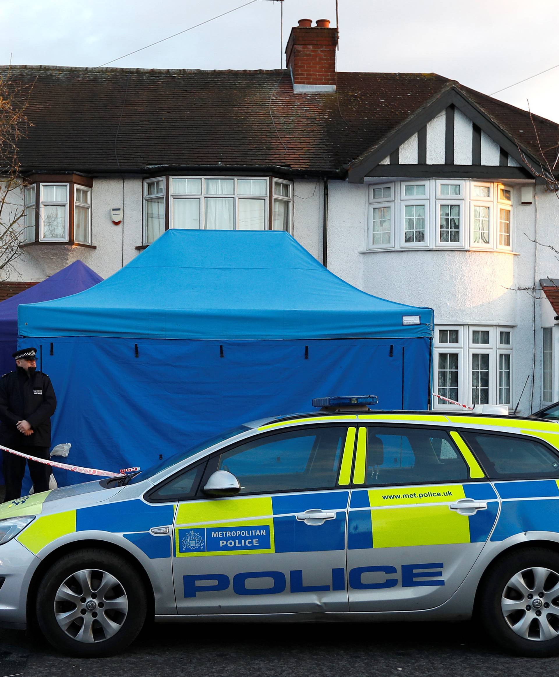 A police officer stands guard outside the home of Nikolai Glushkov in New Malden