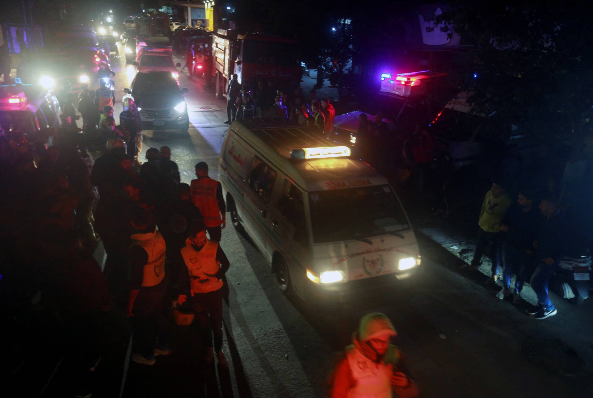 Ambulances and firefighting vehicles are seen outside the Palestinian camp in Tyre