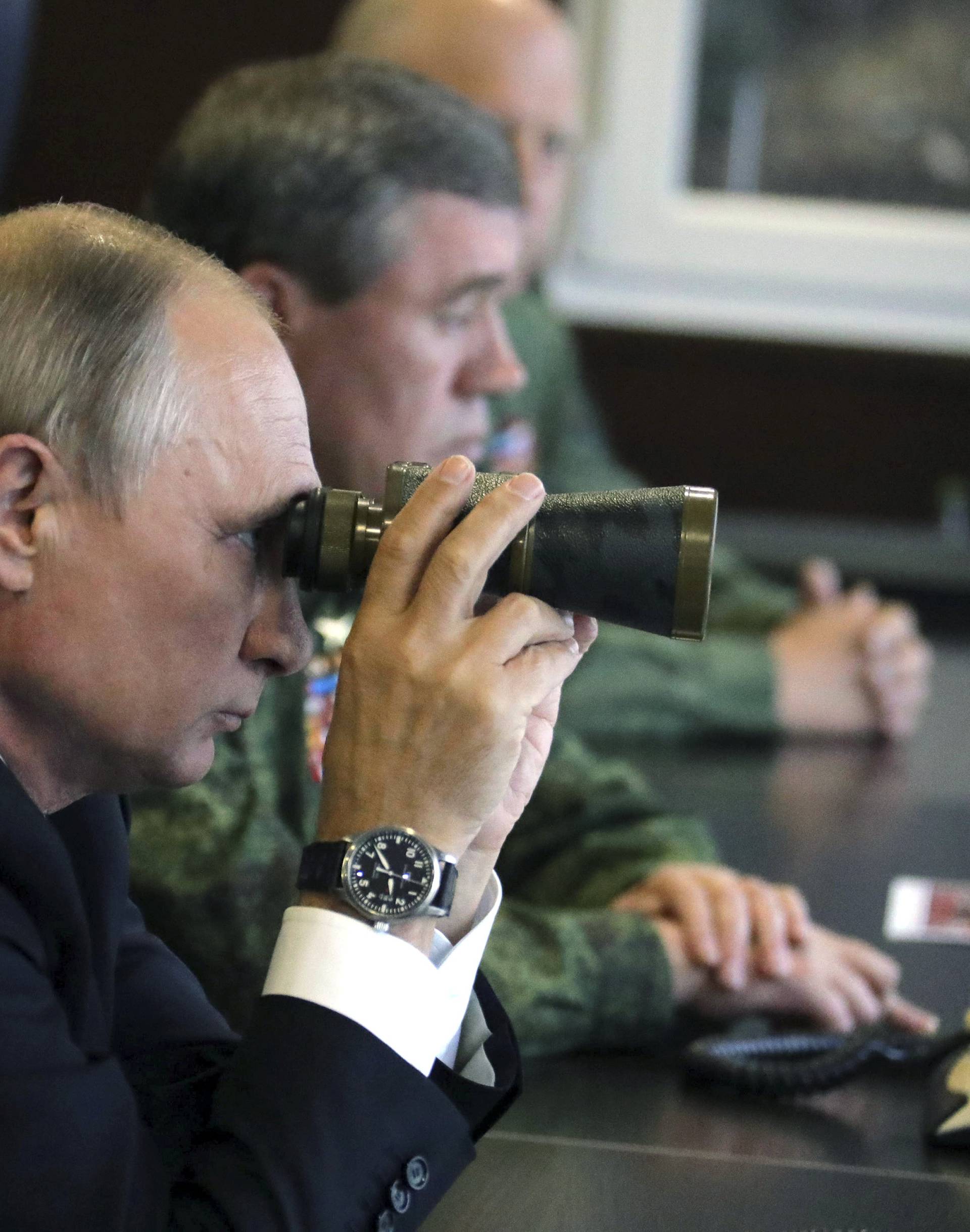 FILE PHOTO: Russian President Putin watches the Zapad-2017 war games at a military training ground in the Leningrad region