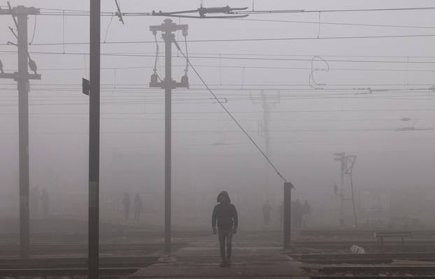 Railway tracks amidst heavy fog on a cold winter morning in New Delhi