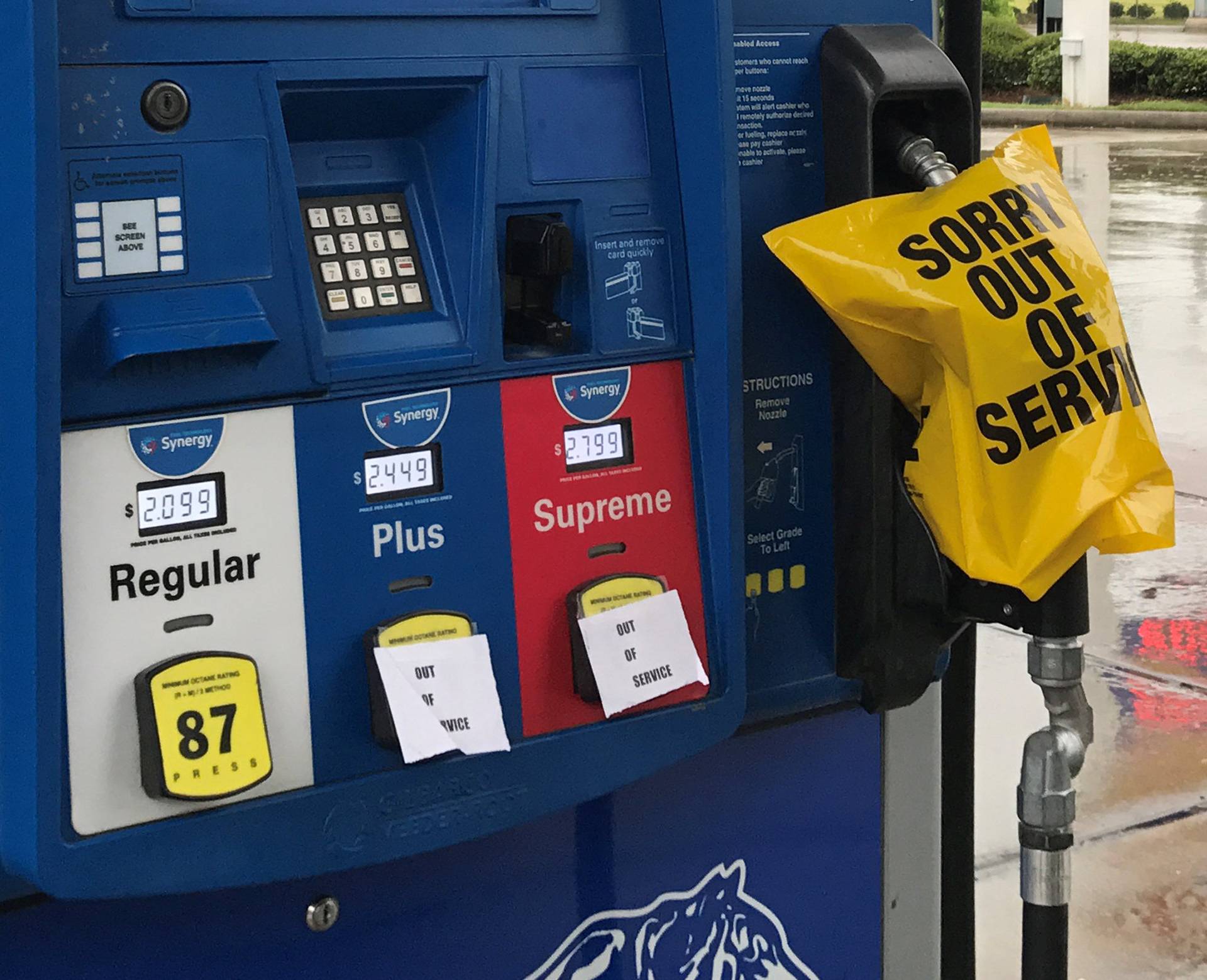 A gas pump is covered with an out of service message as fuel ran out ahead of Hurricane Harvey's arrival near the Texas coastal area, in Houston