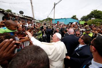 Pope Francis greets people in a neighbourhood in Cartagena