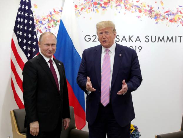 FILE PHOTO: Russia's President Vladimir Putin and U.S. President Donald Trump attend a meeting on the sidelines of the G20 summit in Osaka