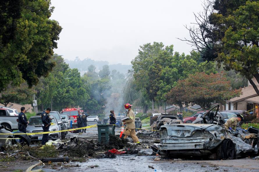 Crash scene after a civilian aircraft went down in a military neighborhood, in San Diego