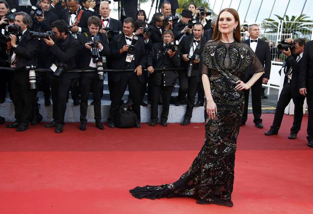 Actress Julianne Moore poses on the red carpet as she arrives for the opening ceremony and the screening of the film "Cafe Society" out of competition during the 69th Cannes Film Festival in Cannes