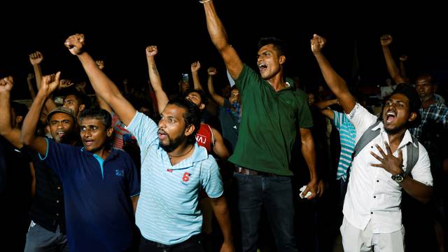 People dance as they celebrate the resignation of Sri Lanka’s President Gotabaya Rajapaksa at a protest site, amid the country’s economic crisis, in Colombo