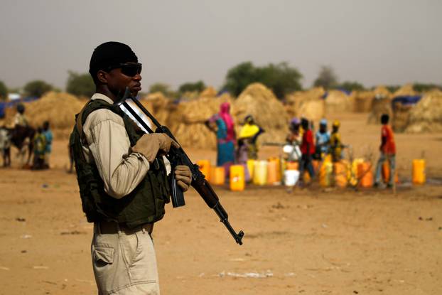 A Nigerien soldier stands guard in a camp of the city of Diffa during the visit of Niger