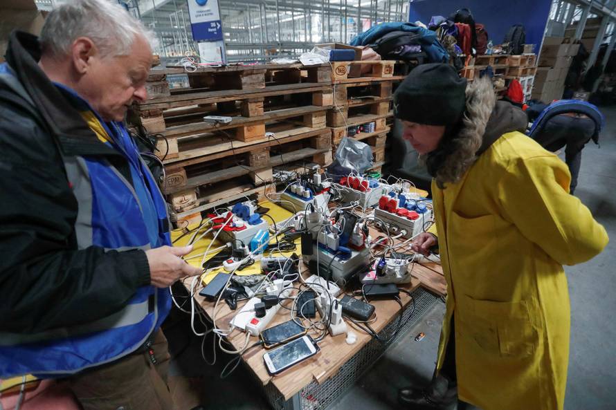 People receive humanitarian aid in Mariupol
