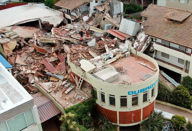 Firefighters search for trapped people after a hotel collapses in Villa Gesell