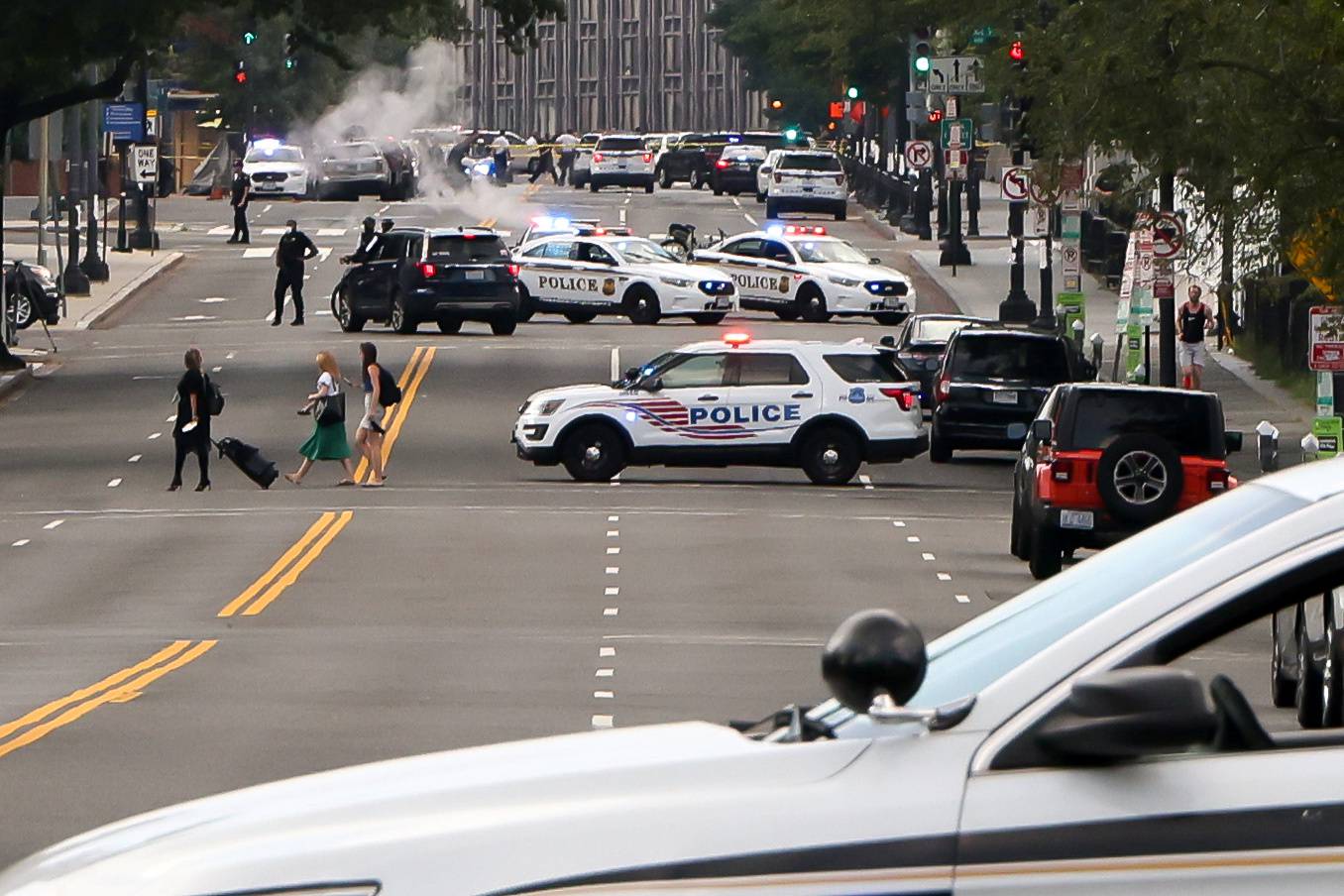 Police officers stand guard after a shooting incident outside the White House, in Washington