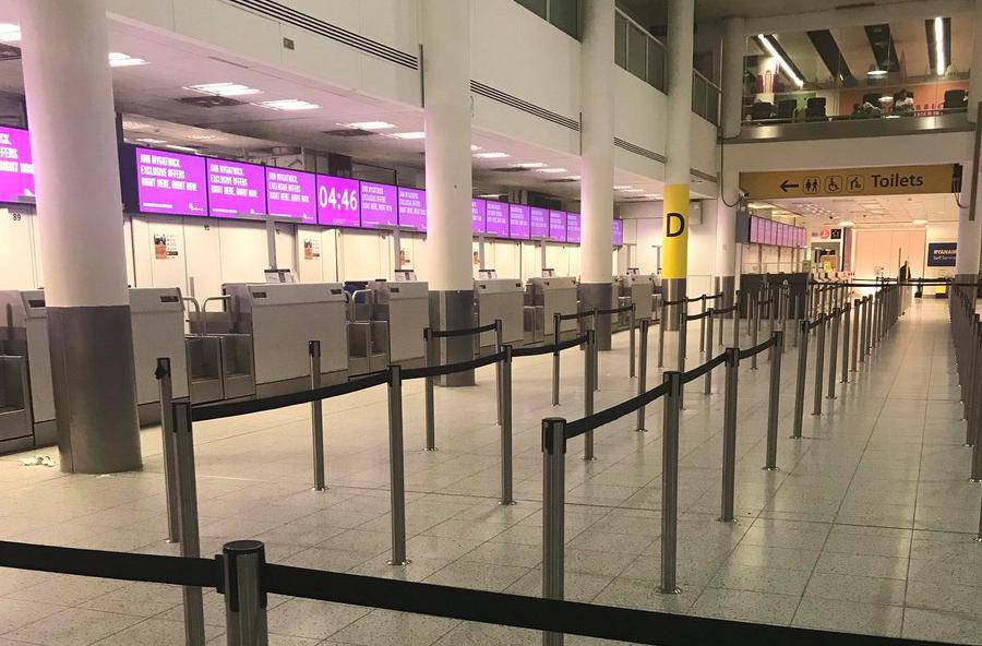 An empty check-in desk for Monarch Airlines is pictured at Gatwick Airport, London