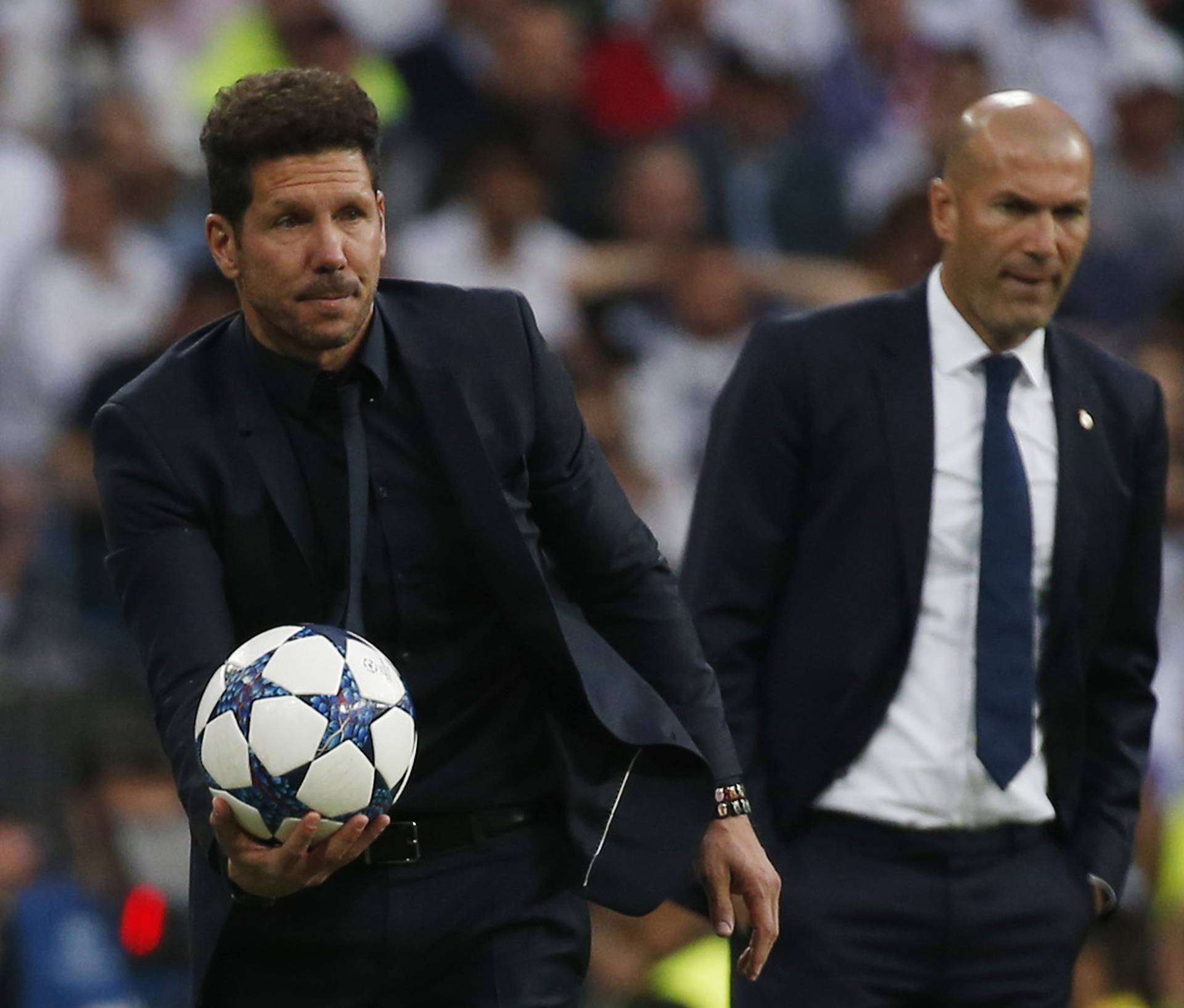 Atletico Madrid coach Diego Simeone as Real Madrid coach Zinedine Zidane looks on