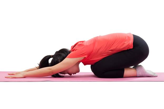 Woman doing yoga child pose