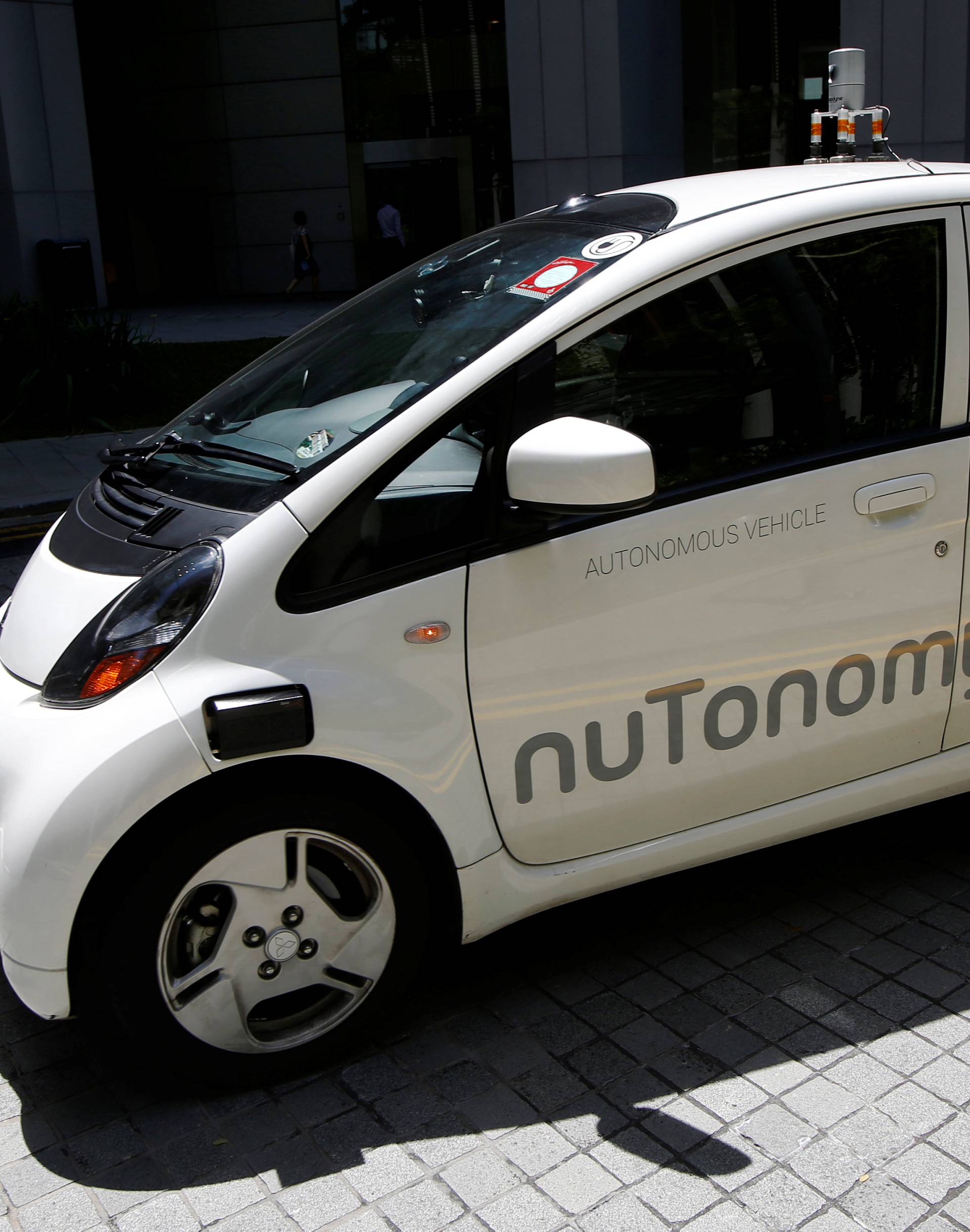 A nuTonomy self-driving taxi drives on the road in its public trial in Singapore 
