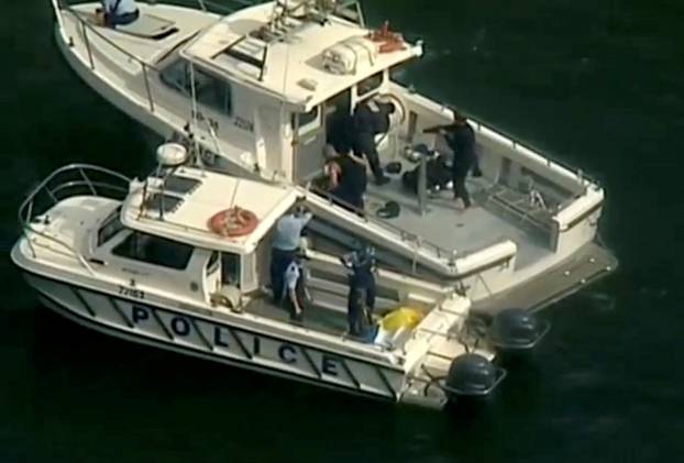 Police vessels are seen after a seaplane crashed into a Sydney river