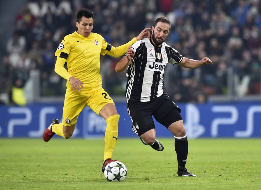 Dinamo Zagreb's Leonardo Sigali in action with Juventus' Gonzalo Higuain