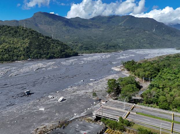 A drone view shows a collapsed bridge and flooded area, following Super Typhoon Ragasa, in Hualien